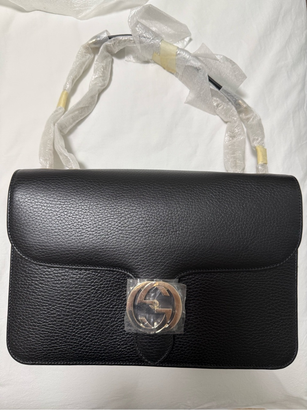 Black Leather Shoulder Bag with Interlocking Metal Accent